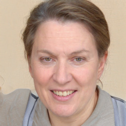 Joyful white adult female with medium  brown hair and blue eyes