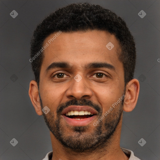 Joyful black young-adult male with short  black hair and brown eyes