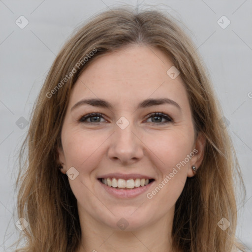 Joyful white young-adult female with long  brown hair and brown eyes