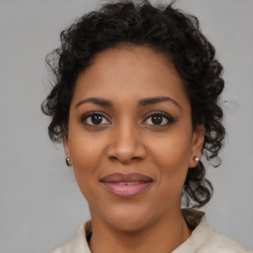 Joyful black young-adult female with medium  brown hair and brown eyes