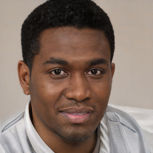 Joyful black young-adult male with short  black hair and brown eyes