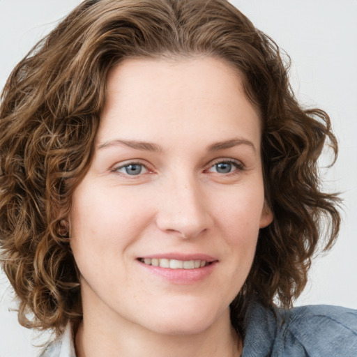 Joyful white young-adult female with medium  brown hair and blue eyes