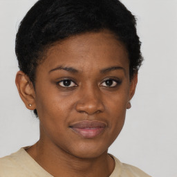 Joyful black young-adult female with short  brown hair and brown eyes