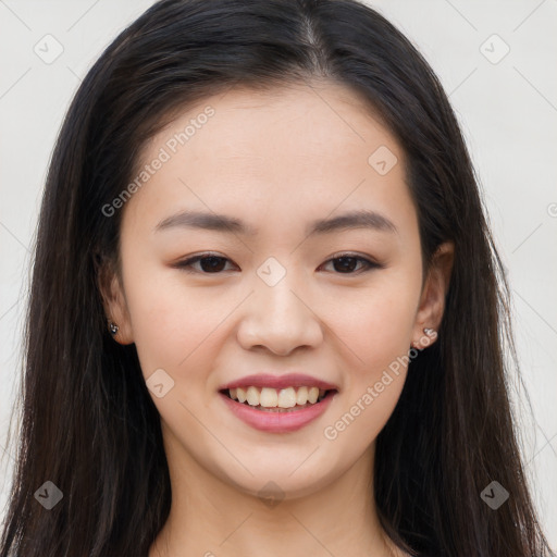 Joyful asian young-adult female with long  brown hair and brown eyes