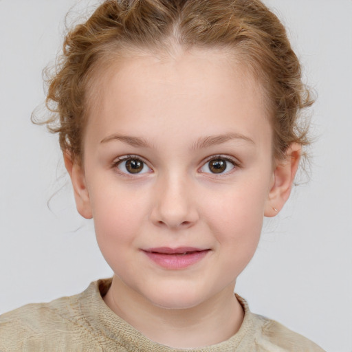 Joyful white child female with short  brown hair and grey eyes