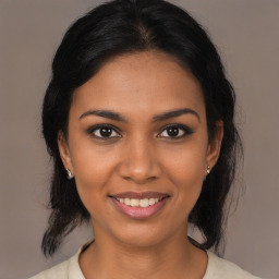 Joyful black young-adult female with medium  brown hair and brown eyes