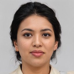 Joyful latino young-adult female with medium  brown hair and brown eyes