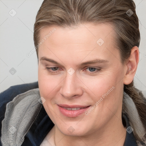 Joyful white young-adult female with medium  brown hair and grey eyes