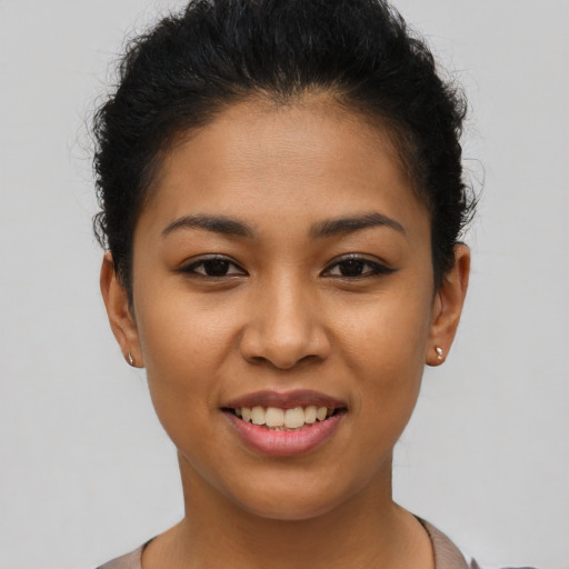Joyful latino young-adult female with short  brown hair and brown eyes