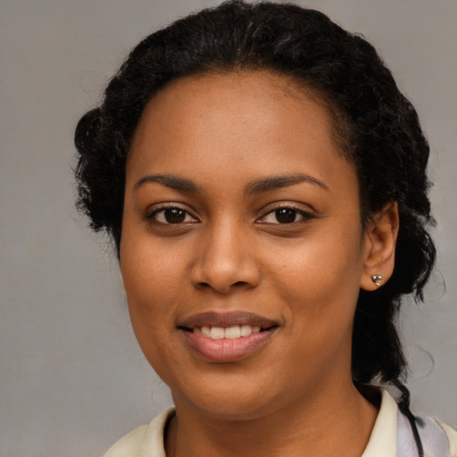 Joyful black young-adult female with medium  brown hair and brown eyes