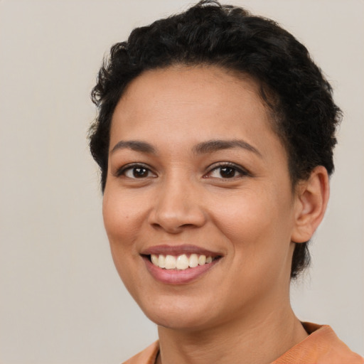 Joyful latino young-adult female with short  brown hair and brown eyes