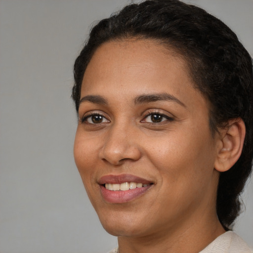 Joyful white young-adult female with short  black hair and brown eyes