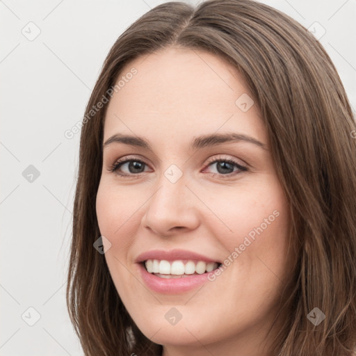 Joyful white young-adult female with long  brown hair and green eyes