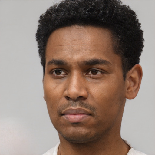 Neutral black young-adult male with short  black hair and brown eyes