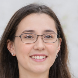 Joyful white adult female with long  brown hair and brown eyes