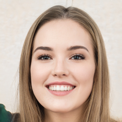 Joyful white young-adult female with long  brown hair and green eyes