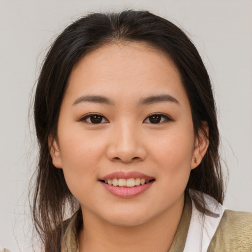 Joyful asian young-adult female with medium  brown hair and brown eyes