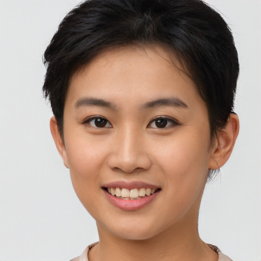 Joyful asian young-adult female with short  brown hair and brown eyes