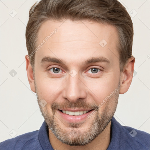 Joyful white adult male with short  brown hair and grey eyes