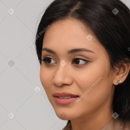 Joyful latino young-adult female with long  brown hair and brown eyes