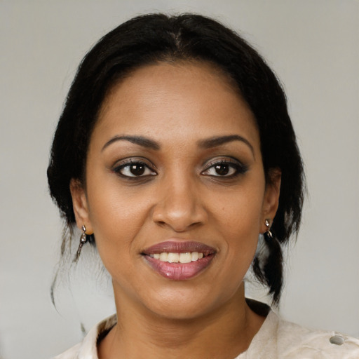 Joyful black young-adult female with medium  brown hair and brown eyes