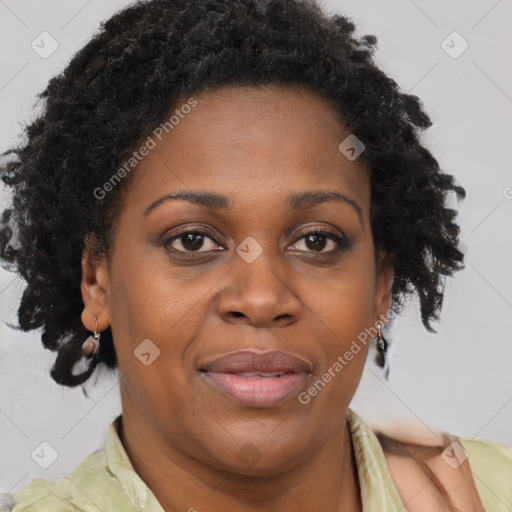 Joyful black adult female with long  brown hair and brown eyes