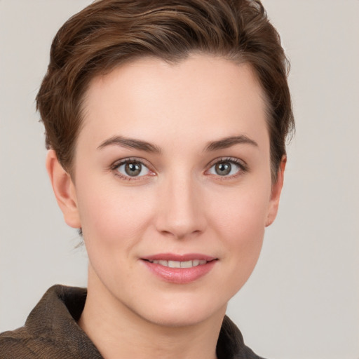 Joyful white young-adult female with short  brown hair and grey eyes