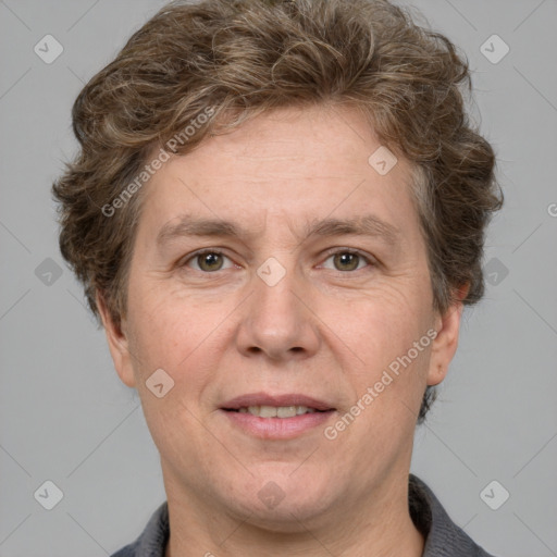 Joyful white adult male with short  brown hair and grey eyes