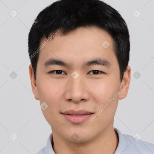 Joyful asian young-adult male with short  black hair and brown eyes