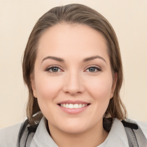 Joyful white young-adult female with medium  brown hair and brown eyes