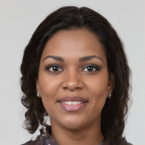 Joyful black young-adult female with medium  brown hair and brown eyes