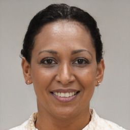 Joyful black adult female with short  brown hair and brown eyes