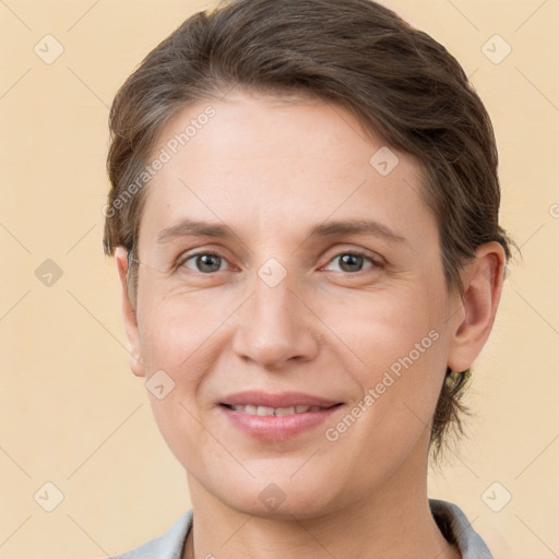 Joyful white adult female with short  brown hair and grey eyes