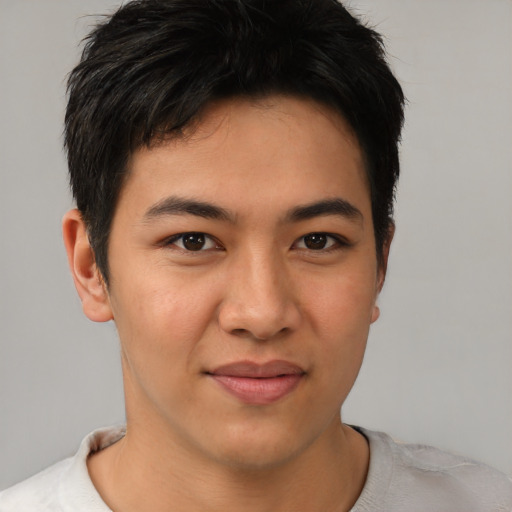 Joyful asian young-adult male with short  brown hair and brown eyes