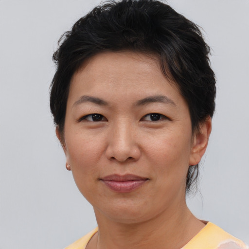 Joyful asian adult female with short  brown hair and brown eyes