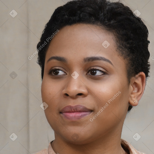 Joyful black young-adult female with short  black hair and brown eyes