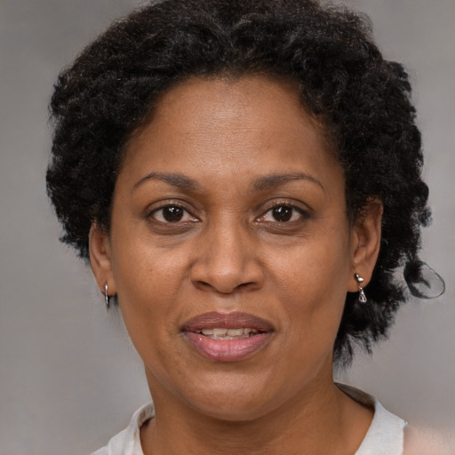 Joyful black adult female with short  brown hair and brown eyes