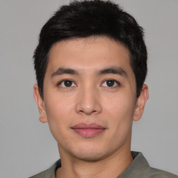 Joyful asian young-adult male with short  black hair and brown eyes