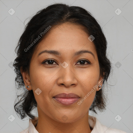 Joyful latino adult female with medium  brown hair and brown eyes