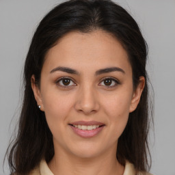 Joyful latino young-adult female with medium  brown hair and brown eyes