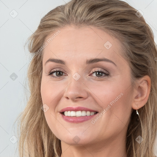 Joyful white young-adult female with long  brown hair and grey eyes