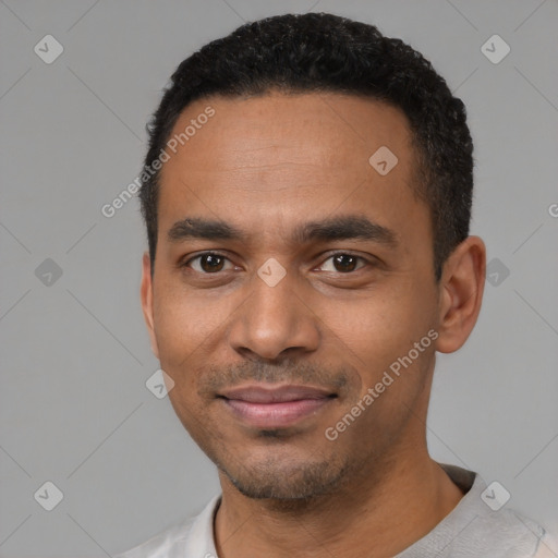 Joyful black young-adult male with short  black hair and brown eyes