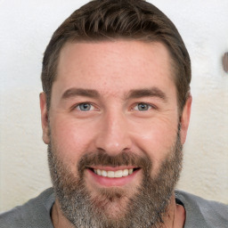 Joyful white adult male with short  brown hair and grey eyes