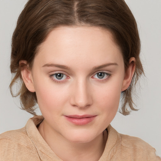 Joyful white young-adult female with medium  brown hair and blue eyes