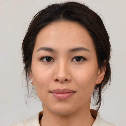 Joyful asian young-adult female with medium  brown hair and brown eyes