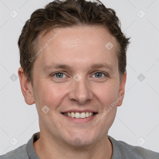 Joyful white adult male with short  brown hair and grey eyes