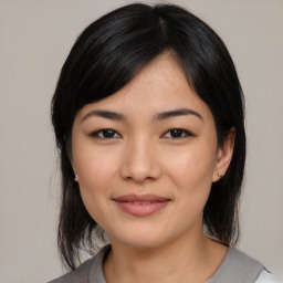 Joyful asian young-adult female with medium  black hair and brown eyes