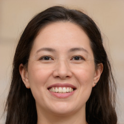 Joyful white adult female with long  brown hair and brown eyes