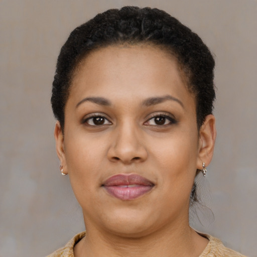Joyful latino adult female with short  brown hair and brown eyes