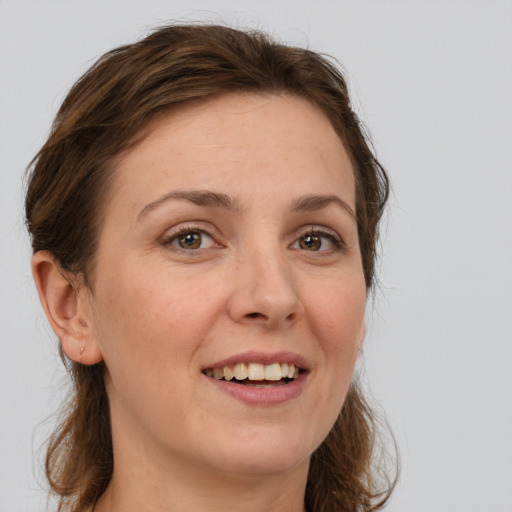 Joyful white young-adult female with medium  brown hair and grey eyes